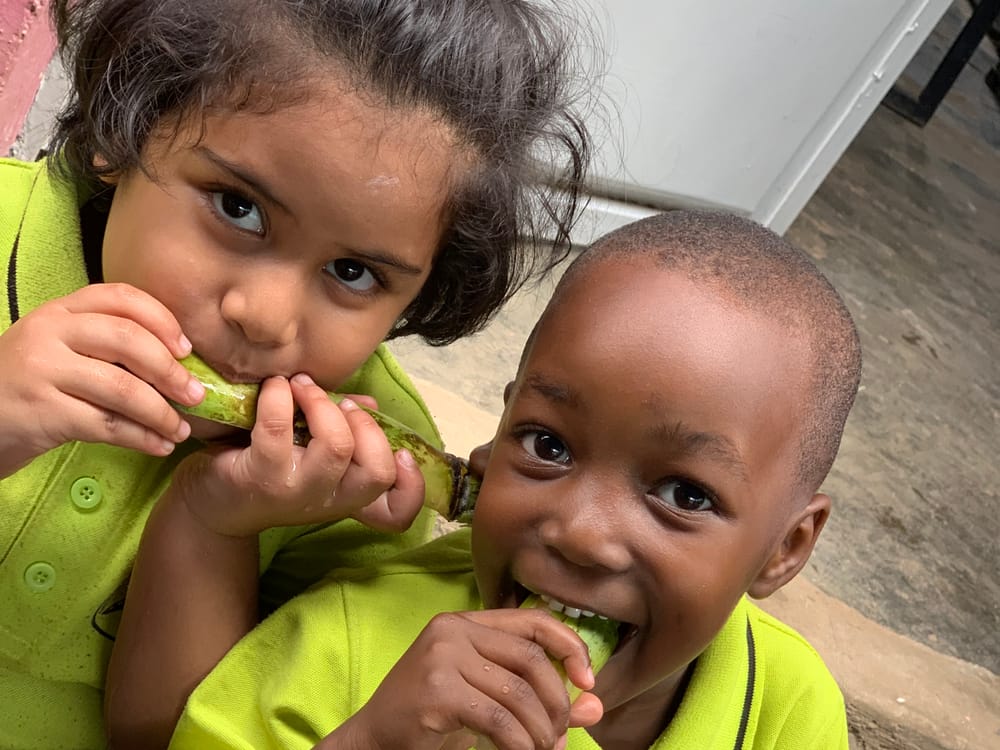 Two kindergarten children at snack time outside their classroom